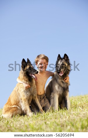 happy laughing boy with two dogs