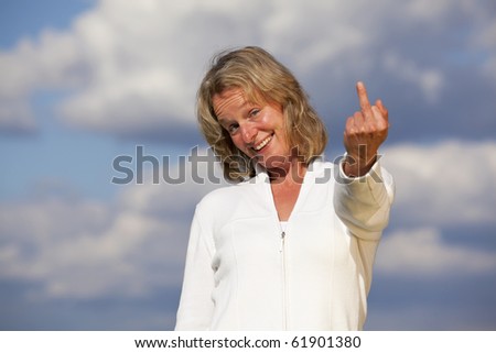 smiling blond mature woman showing middle finger