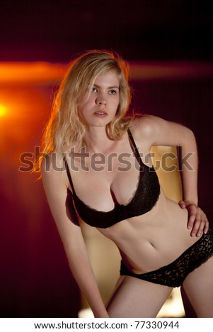 beautiful blond lingerie model with light effects in the background