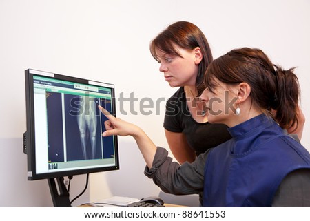 veterinarian explaining x-ray picture to pet owner