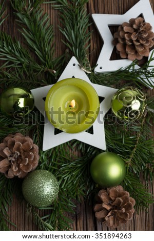 Christmas table decoration for Advent with burning candle\
â??selected focus, narrow depth of fieldâ??