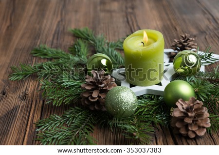 Christmas table decoration for Advent with burning candle\
â??selected focus, narrow depth of fieldâ??