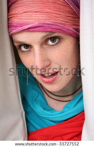 an actress looking through the curtain