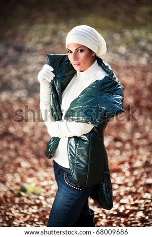 Beautiful girl in white hat and gloves posing outdoor