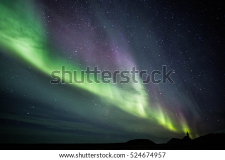Aurora borealis over Budir church in Iceland