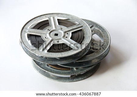 three film reels cinematography with cinema accessories on white background