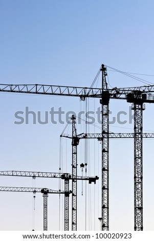 Construction site silhouette with tower cranes