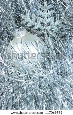 Christmas silver baubles on glittery background