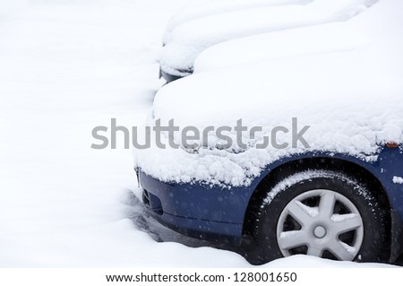 Snow covered cars after winter blizzard