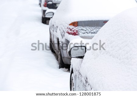Parked cars covered with snow
