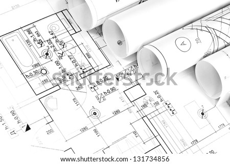 Architectural background with rolls of technical drawings