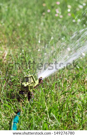 Water spraying from a lawn sprinkler