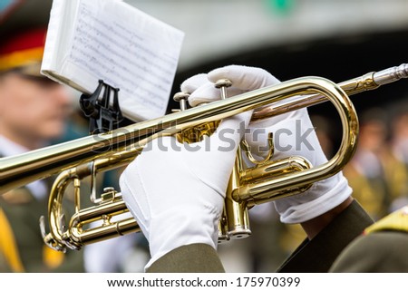 Musician playing the trumpet in military orchestra