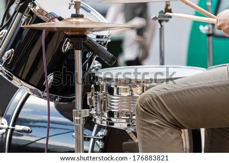 Young man playing the drums on street performance