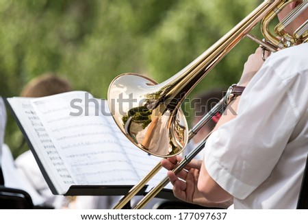 Musician playing the trombone in orchestra