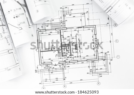 Architectural background with floor plans and rolled technical drawings