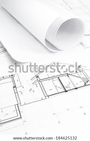 Architectural background with rolls of technical drawings and blueprint