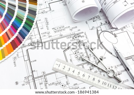 Architect\'s and designer\'s work space during work with technical drawing and color samples catalog