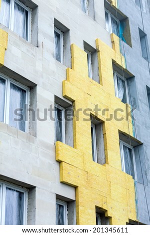 Thermal insulation of building facade with rock wool