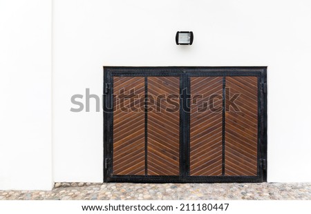 Closed wooden garage gate in historical building wall