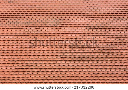 Red roof tiles on the roof of an old house