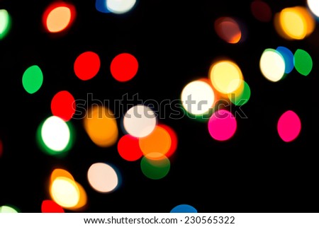 Defocused multicolored light dots against black background