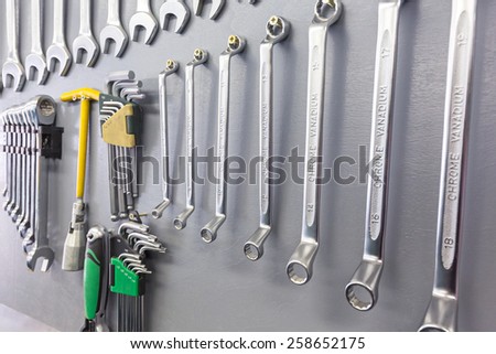 Set of hand tools on wood panel background