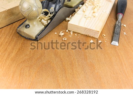 Carpenter??s working tools: plane and chisel with planks and shavings