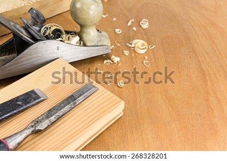 Carpenters working tools: plane and chisels with planks and shavings