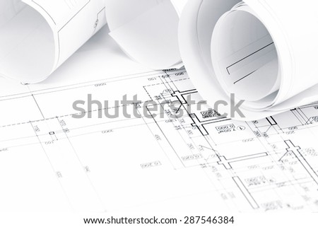 architectural background with floor plans and rolled technical drawings