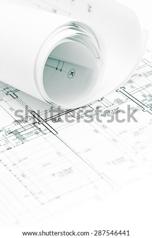 architectural background with rolls of technical drawings and blueprints