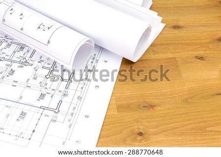 architectural background with floor plans and rolled technical drawings