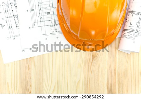 safety helmet with floor plans and rolled technical drawings