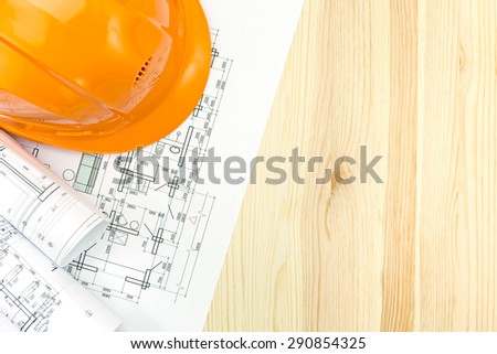 engineer workplace with blueprint and safety helmet
