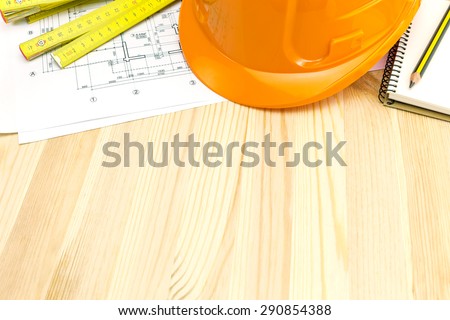 construction plans with safety helmet and carpentry ruler