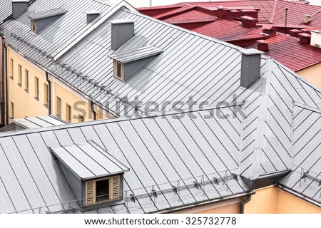 wet new metal roofs of old houses viewed from above