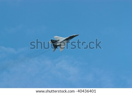 Jet fighter in flight against the dark blue sky