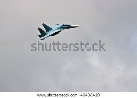 Jet fighter in flight against the blue sky