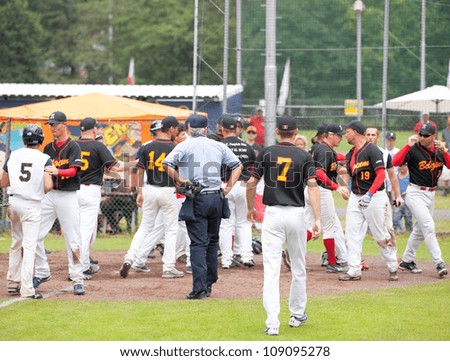 AMSTELVEEN - JULY 28: Players of rival teams of Israel and Belgium engage in a fight during the game at the softball European championship, held on July 28, 2012 in Amstelveen,The Netherlands