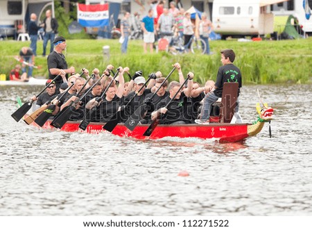 AMSTERDAM - SEP 2: Unidentified paddlers of All in One team participate in Dutch national Dragon boats championships, held on September 2, 2012, Bosbaan, Amsterdam, The Netherlands