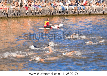 AMSTERDAM - SEP 9: Unidentified swimmers participate in The Amsterdam City Swim, 2028 meters crossing the city canals charity event, held on September 9, 2012, Amsterdam, The Netherlands