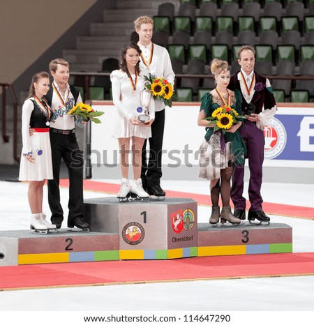OBERSTDORF - SEPT 29: Ice dance winners Madison Chock and Evan Bates of the USA on the podium, with other medalists, during Nebelhorn Trophy medal ceremony on September 29, 2012 in Oberstdorf, Germany