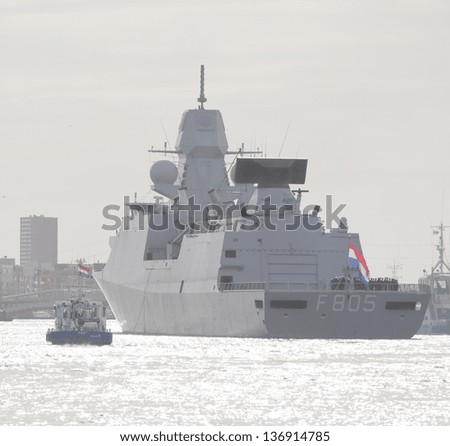 AMSTERDAM - APR 30: Royal Dutch navy frigate Evertsen finishes greeting HRH Queen Beatrix at her arrival in the city with 101 shots deck cannon salute, on April 30, 2013, Amsterdam, The Netherlands