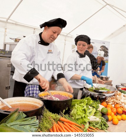AMSTERDAM - JUNE 29: Chefs cook free lunch for the visitors of the Damn Food Waste day at the city\'s Museum Square, June 29, 2013 in Amsterdam, The Netherlands