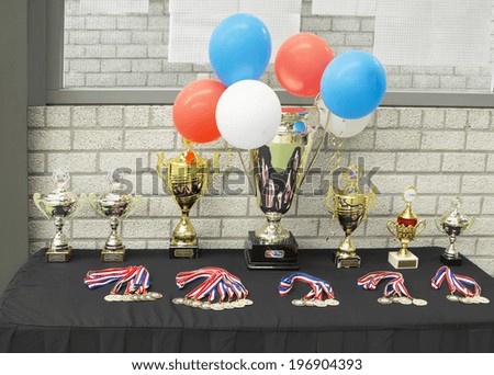 AMSTELVEEN, THE NETHERLANDS - MAY 18, 2014: Trophies and medals on display before the medal ceremony at Dutch Speedminton Open 2014,  international speed badminton competition
