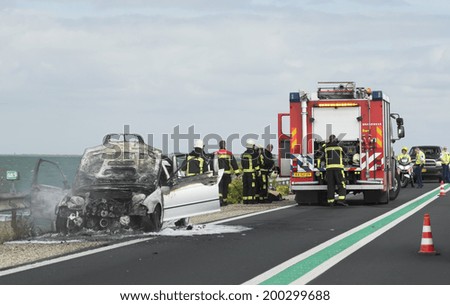 LELYSTAD, THE NETHERLANDS - JUNE 15, 2014: Firefighters and police present at a road traffic accident scene at the Houtrib dam, 26 km long motorway built atop a dam