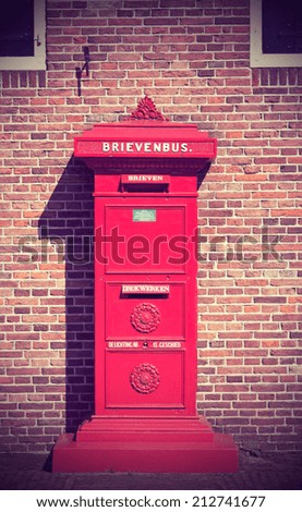 Antique Dutch red mail box. Toned photograph in a retro nostalgic style.