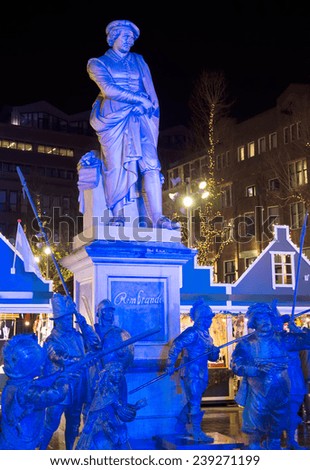 AMSTERDAM, THE NETHERLANDS - DEC 20, 2014: Statues of Rembrandt and the Night Watch characters amid of the Christmas fair, held annually at the city\'s Rembrandt Square.