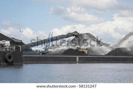 Conveyor belt processing stockpiles of bulk cargo in port