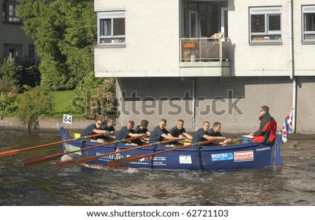 AMSTERDAM, THE NETHERLANDS - OCT 9: Rowing team from Friesland participates in the annual 25 km long canal race, October 9, 2010 in Amsterdam, The Netherlands